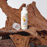 Vitamin C Serum bottle on a wooden surface with a white background