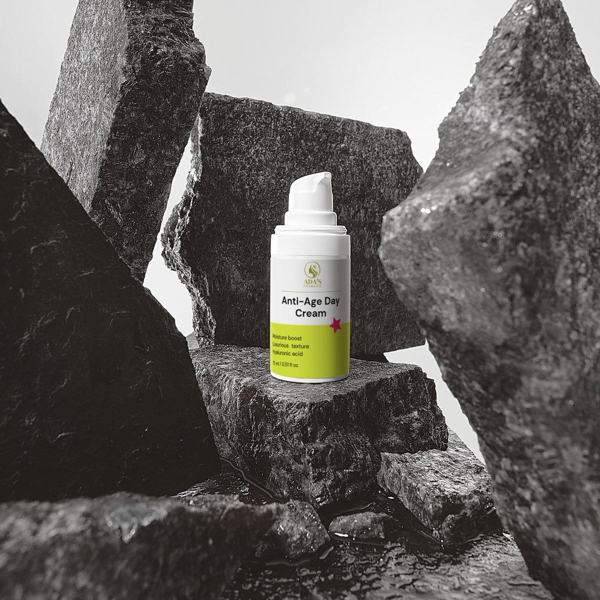 Anti-aging cream bottle on a rocky surface with a gray background