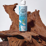 Bottle of gentle cleansing milk on a wooden surface