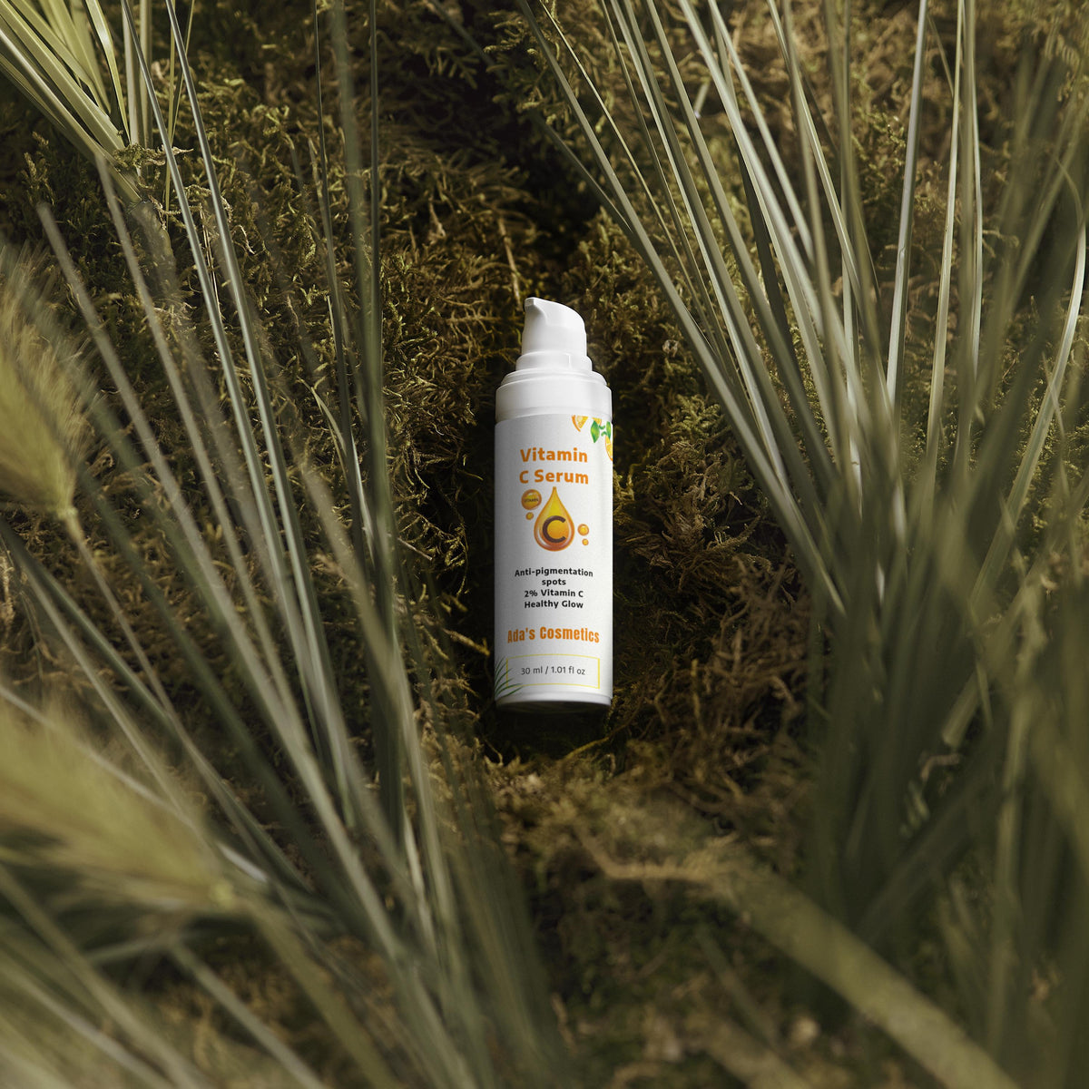 Vitamin C serum bottle on a natural background with plants
