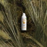 Vitamin C serum bottle on a natural background with plants
