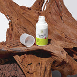 Anti-age day cream bottle with green label on a wooden surface