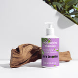 Moisturising Shampoo bottle with a purple label on a white surface with greenery in the background